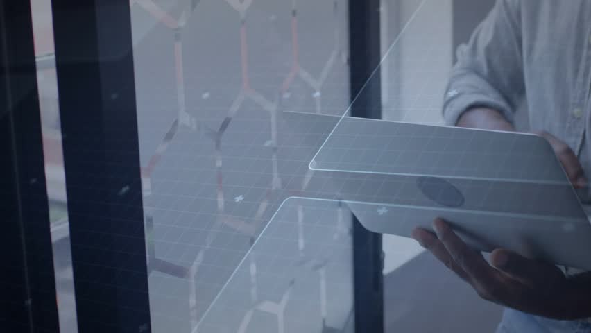 man shifting grip and opening laptop, tapping keys while holographic data animating tech functions. Futuristic, digital, innovation, workplace, analysis, technology, modern
