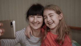 Video Call Family Selfie. Portrait Mother and Kids Kissing on Camera. Happy Mother With Her Kids are Making Selfie or Video Call to Father or Relatives in Bed. Technology, New Generation Parenthood. - Powered by Shutterstock - Get 15% off with code: PIKWIZARD15