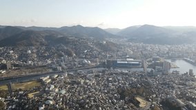 Drone footage over Nagasaki, a historic port city on Kyushu Island in Japan. Nestled between mountains and the sea, Nagasaki blends modern urban life with scenic landscapes. - Powered by Shutterstock - Get 15% off with code: PIKWIZARD15