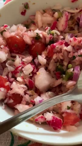 Homemade meal with yellow rice and green peas served alongside fresh avocado slices and grilled meat on a white plate. The traditional dish highlights Latin cuisine, comfort food, and healthy eating w
