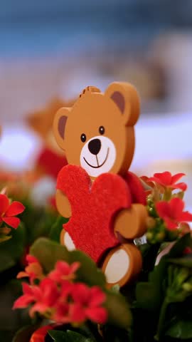 Happy Valentine's Day. close-up. many wooden toys teddy bears, with red felt hearts in flowerpots with flowers. gifts for Valentine's Day, as an expression of feelings and love. sale of various gifts 