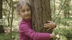 Contented Little Girl Hugging Large Tree With Blissful Expression of Nature Conservation. Harmony Calm Relaxation. Save Earth Green Planet. Child Girl Hugging Tree Trunk in Park, Nature Life Love. - Powered by Shutterstock - Get 15% off with code: PIKWIZARD15