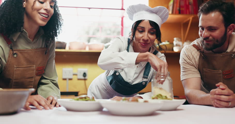 Cooking class, chef and couple with dish in kitchen for culinary skills, learning recipe and gourmet. Lesson, instruction and woman with man with ingredients, food and cuisine for dinner or meal prep
