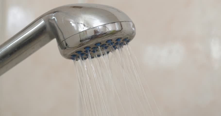 Water flows out of the shower head. Turning off the water from the shower. Shower head in bathroom, chrome faucet, close-up shot video