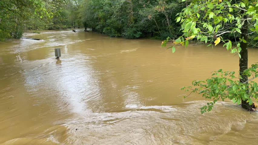 Camera pans to show north Georgia creek overwhelmed by floodwaters from Hurricane Helene.