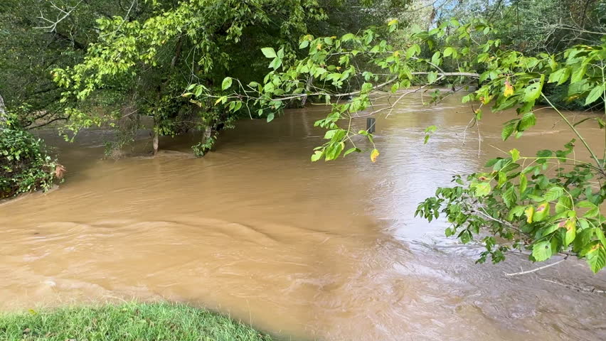 Tracking shot shows floodwaters from Hurricane Helene completely swamping a north Georgia creek. 