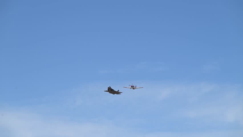 US Air Force air show featuring flight demonstrations of F-35 and P-51 fighter jets.