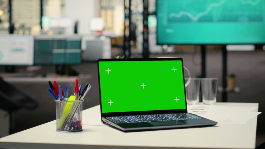 Green screen mockup on laptop in empty corporate workspace, human resources department office and desk prepared for hiring process, interviews and career development. Chroma key.