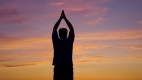 Sports, man warms up, trains his body, raising his arms outdoors, warming up for outdoor fitness. Healthy lifestyle. Breathing exercises outdoors, arm swings in park in morning, evening, training, sky - Powered by Shutterstock - Get 15% off with code: PIKWIZARD15