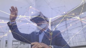 Businessman wearing VR headset lifting hand sweeping lines and pinching nodes optimizing data flow. Technology, innovation, connectivity, network, futurism, professional, digital - Powered by Shutterstock - Get 15% off with code: PIKWIZARD15