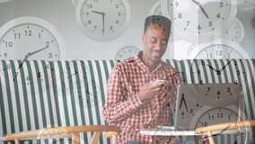 Man tapping smartphone and activating animated clock cascade while referencing PC for business call. Technology, communication, remote, productivity, digital, casual, modern - Powered by Shutterstock - Get 15% off with code: PIKWIZARD15