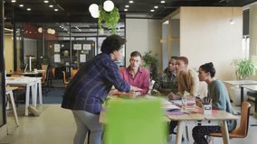 woman distributing color diagrams showing media prompts flashing around business team collaborating. Collaboration, teamwork, brainstorming, office, modern, productivity, communication - Powered by Shutterstock - Get 15% off with code: PIKWIZARD15