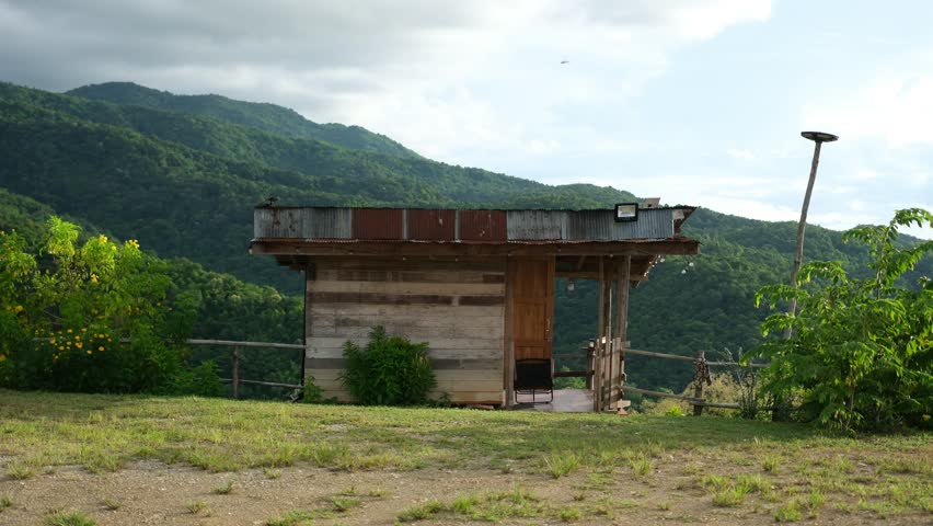 A small wooden cabin in the woods and mountains