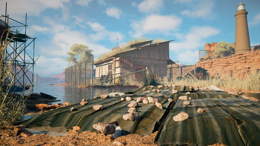 Abandoned lakeside shack with overgrown roof and broken fence, beside rocky cliffs and a tall lighthouse, viewed across water with scattered debris in the foreground.