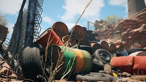 A pile of rusted metal barrels and old tires stacked in a junkyard, set against rocky terrain and a clear blue sky. Rusty barrels and tires piled outdoors in a junkyard. - Powered by Shutterstock - Get 15% off with code: PIKWIZARD15