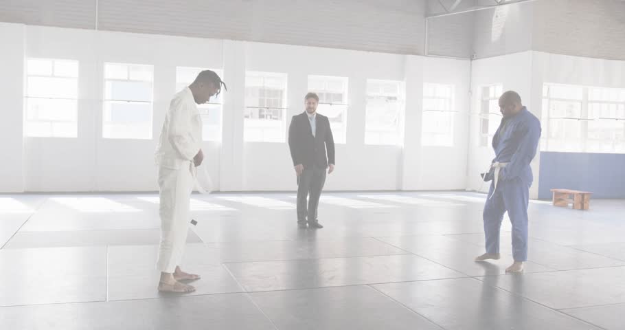 Martial artists stepping onto mat as floating metrics climbing until phone stomping vanishing data. Martial arts, competition, digital, overlay, focus, discipline, confrontation