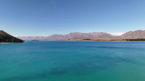 A 4K drone pans around the picturesque Lake Tekapo in New Zealand. Drone captures turquoise waters, mountains, and surrounding alpine scenery for a stunning aerial view. - Powered by Shutterstock - Get 15% off with code: PIKWIZARD15