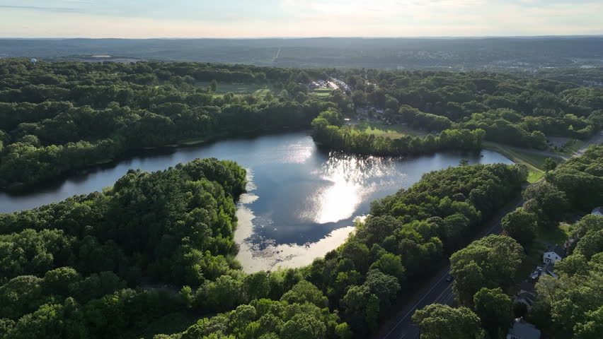 Lake Surrounded With Lush Green Vegetation In New Haven, Connecticut - Drone Shot