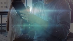 Man picking up tablet tilting toward colleague, initiating holographic UI forming for tech demo. Futuristic, innovation, collaboration, technology, digital, interface, urban - Powered by Shutterstock - Get 15% off with code: PIKWIZARD15