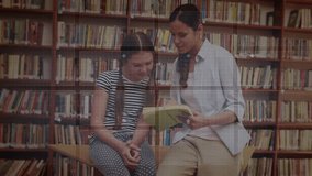 Mid-adult woman turning book page sparking holographic charts guiding student learning in library. Education, mentorship, technology, innovation, literacy, collaboration, curiosity - Powered by Shutterstock - Get 15% off with code: PIKWIZARD15