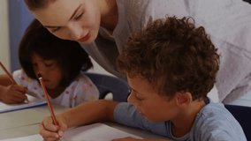 Boy writing notebook triggers teacher guiding pencil as pulsing medical icons framing health class. Educator, student, classroom, instruction, learning, focused, mentorship - Powered by Shutterstock - Get 15% off with code: PIKWIZARD15