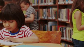 Boy sitting library reading book, turning pages causing compass pin cloud globe icons fading. Student, literacy, education, knowledge, exploration, learning, concentration - Powered by Shutterstock - Get 15% off with code: PIKWIZARD15