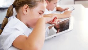 Girl tapping tablet in classroom, activating swirling edtech UI circles visualizing student network. Children, digital learning, user interface, education technology, classroom, connectivity, - Powered by Shutterstock - Get 15% off with code: PIKWIZARD15