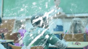 Boy writing in classroom causing glowing network lines forming shield lock showing data security. Education, e-learning, digital, cybersecurity, innovation, teamwork, learning - Powered by Shutterstock - Get 15% off with code: PIKWIZARD15