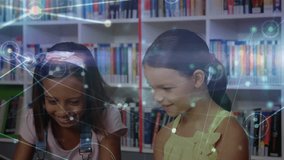 Girls tapping tablets in library while network overlay fading in sparking collaborative learning. Children, education, collaboration, technology, library, learning, digital - Powered by Shutterstock - Get 15% off with code: PIKWIZARD15