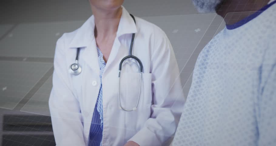 Doctor accessing blue holographic interface in clinic while reviewing vitals and reassuring patient. Medical, technology, healthcare, innovation, diagnostic, clinical, professional