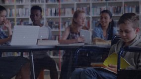 Boy in wheelchair turning page in library while peers reading as holographic interface animating. Education, collaboration, accessibility, innovation, learning, technology, diversity - Powered by Shutterstock - Get 15% off with code: PIKWIZARD15