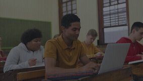 After settling male student typing on laptop in classroom and code overlay showing tech. Education, teamwork, innovation, learning, digital, youth, technology - Powered by Shutterstock - Get 15% off with code: PIKWIZARD15