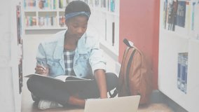 Student writing notes with laptop in library while network icons emerging showing digital learning. Educational, study, concentration, innovation, technology, learning, academic - Powered by Shutterstock - Get 15% off with code: PIKWIZARD15