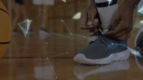 Teen basketball player tying shoelaces and initiating overlay as coach palm showing rotating globe. Athlete, training, connectivity, innovation, teamwork, education, sports - Powered by Shutterstock - Get 15% off with code: PIKWIZARD15