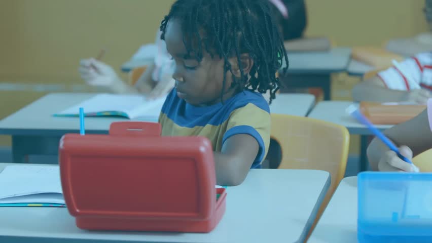 Boy writing beside red tablet causing floating data panels while girl writing lines in classroom. Education, technology, innovation, classroom, learning, digital, teamwork - Powered by Shutterstock - Get 15% off with code: PIKWIZARD15