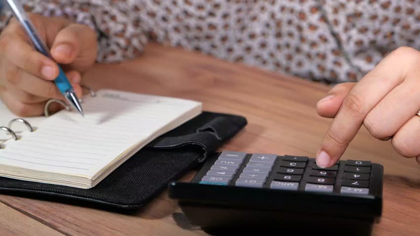 
Person doing calculations on a notepad and calculator 4k video - Powered by Shutterstock - Get 15% off with code: PIKWIZARD15