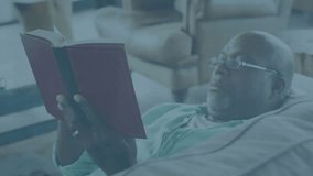 Senior man reading red book, data overlay appearing and updating bar charts graphs for business. Senior, leisure, analytics, visualization, relaxation, home, intelligence - Powered by Shutterstock - Get 15% off with code: PIKWIZARD15