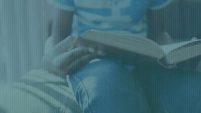 binary overlay appearing guiding boy turning book pages on gray sofa enriching technology education. Child, reading, focus, literacy, digital, education, technology - Powered by Shutterstock - Get 15% off with code: PIKWIZARD15