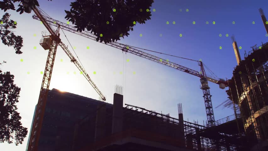 Binary overlay cascading across tower cranes above frame, crane hook lowering showing structure. Technology, construction, engineering, digital, innovation, industry, architecture
