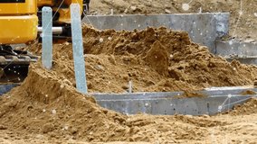 Excavator bucket entering scooping lifting dumping soil on trench for leveling with data overlay. Construction, machinery, industrial, technology, infrastructure, excavation, automation - Powered by Shutterstock - Get 15% off with code: PIKWIZARD15