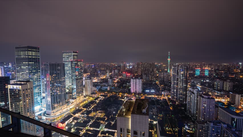 Stunning aerial night view of Chengdu city skyline featuring illuminated skyscrapers, IFS tower, and urban landscape with vibrant city lights and modern architecture.