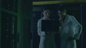 Woman opening laptop and man monitoring encryption in server room with code overlays to secure file. Cybersecurity, data protection, digital infrastructure, technological, futuristic, collaboration, - Powered by Shutterstock - Get 15% off with code: PIKWIZARD15