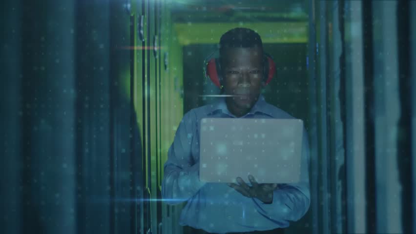 IT security engineer initiating scan on laptop and monitoring rising malware alerts in server aisle. Cybersecurity, technology, network, data, protection, digital, surveillance - Powered by Shutterstock - Get 15% off with code: PIKWIZARD15