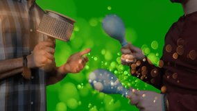 Musicians rotating cabasa and shaking maracas on green screen initiating bokeh for music production. Percussion, rhythm, collaboration, entertainment, motion, abstract, vibrant - Powered by Shutterstock - Get 15% off with code: PIKWIZARD15
