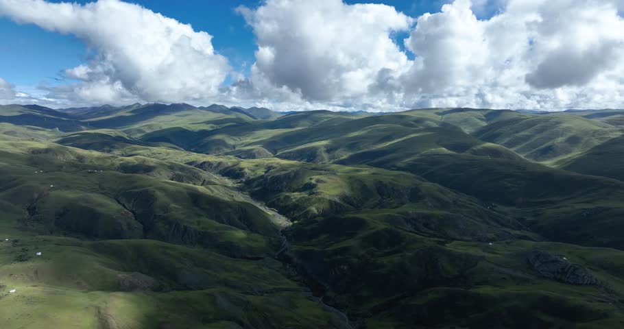 Beautiful green grassland and cloudy sky in Litang county, China
