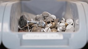 Rack focus reveals 'decorative tacks' label on bin filled with metal tacks - Powered by Shutterstock - Get 15% off with code: PIKWIZARD15