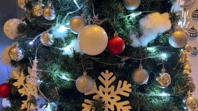 4k footage close up of lighted Christmas tree ornaments and decorations. Mistletoe, baubles, and bell with Interactive sparkling christmas twinkle lights or icicle lights. - Powered by Shutterstock - Get 15% off with code: PIKWIZARD15