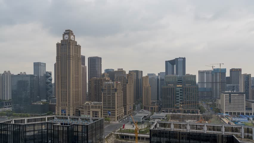 Chengdu CBD skyline timelapse showing modern skyscrapers and high-tech business district during day to night transition with cloudy sky over China