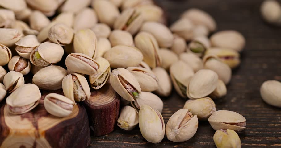 unpeeled pistachio fried in salt, scattered salted pistachios after roasting with cracked shells