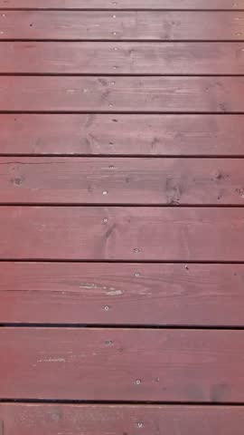 Wooden footbridge with fixed planks over the river and view of the city at sunrise